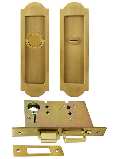Premium Pocket-Door Mortise Lock Set with Arched Pulls in Aged Brass.